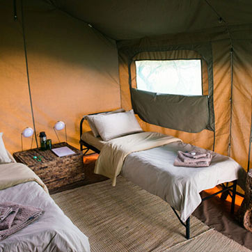 Two cots inside a tent in Karenge Bush Camp